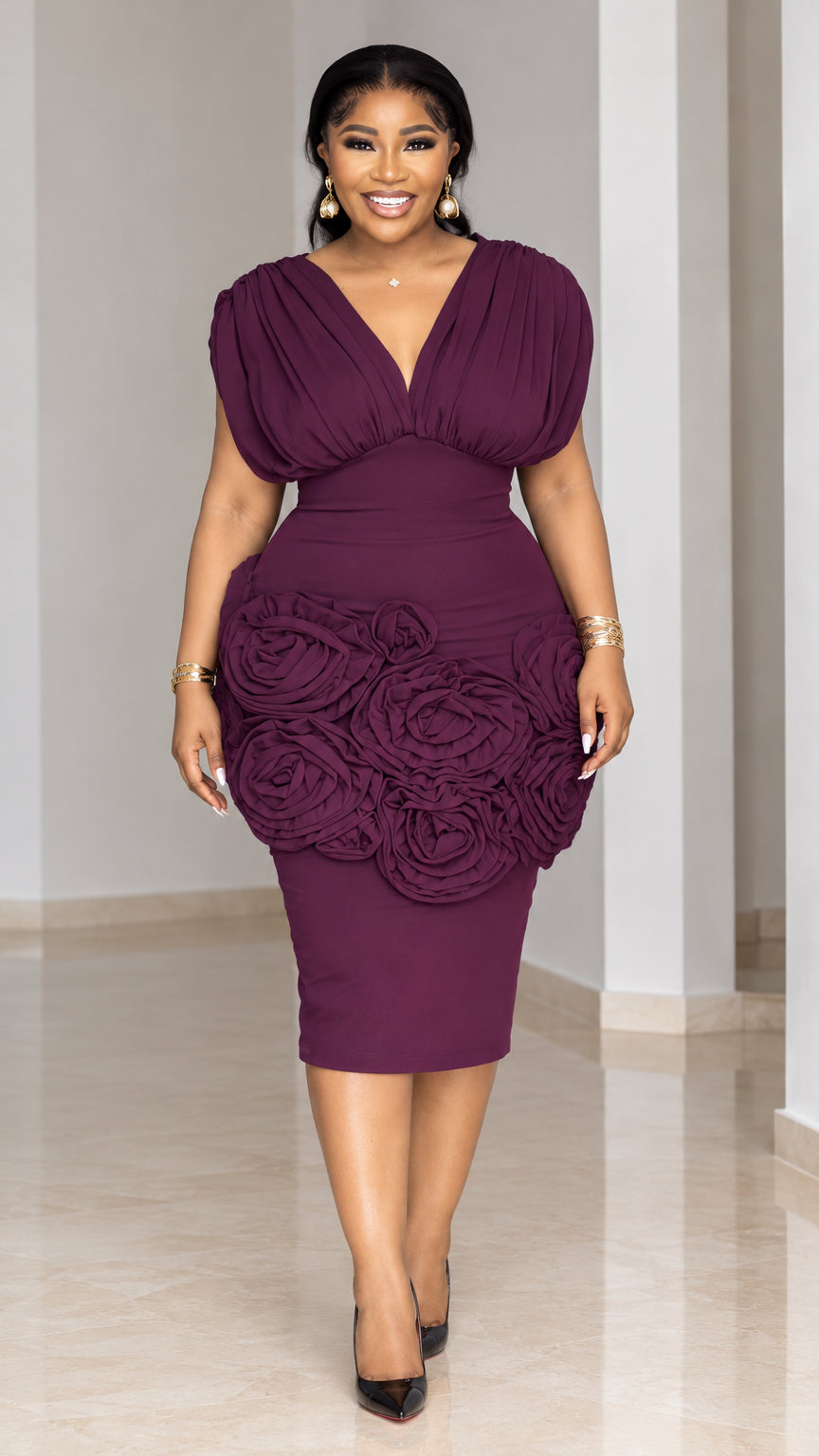 Front view of model wearing plum sleeveless V-neck midi dress with 3D rosettes on hips