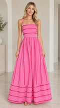 Front full-length view of woman wearing hot pink square neck ribbon trim maxi dress