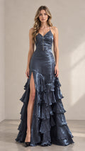 Front full view of woman wearing slate blue tiered ruffle maxi evening gown with high leg slit