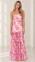 Front full-length view of model wearing strapless pink floral tiered maxi dress