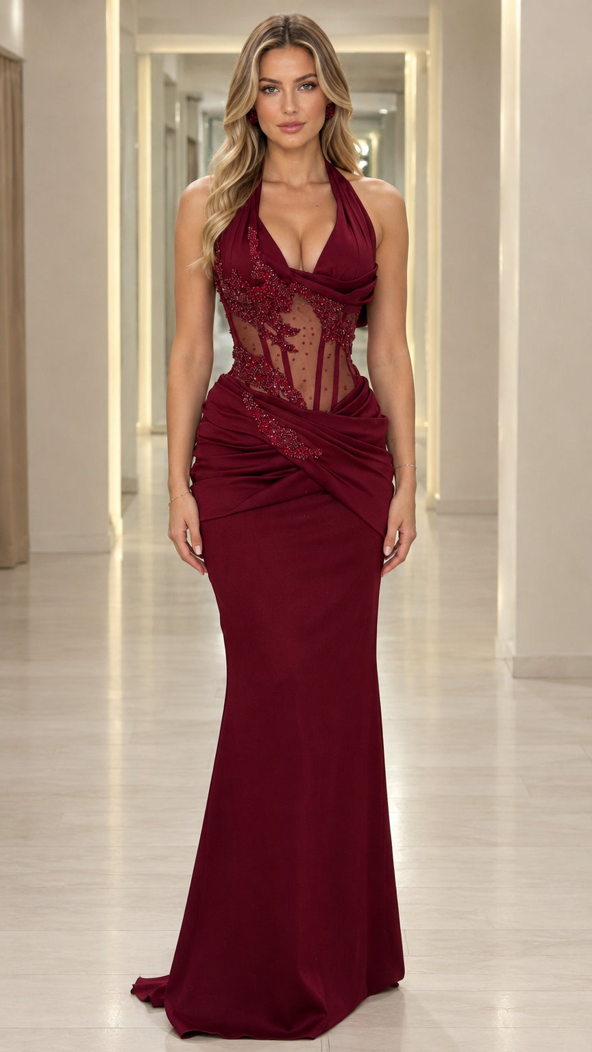Full front view of model wearing burgundy halter evening gown with sheer beaded corset bodice