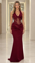 Full front view of model wearing burgundy halter evening gown with sheer beaded corset bodice