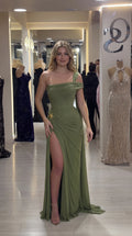Model wearing an olive green one-shoulder ruched formal gown with high leg slit