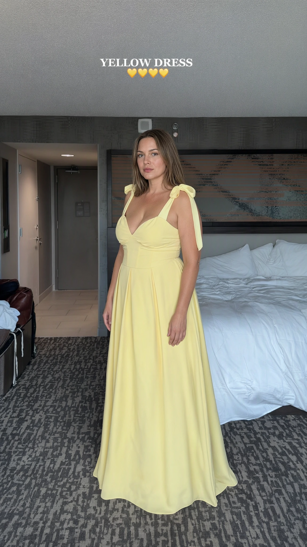 Front view of woman wearing yellow sweetheart maxi dress with tie shoulder straps