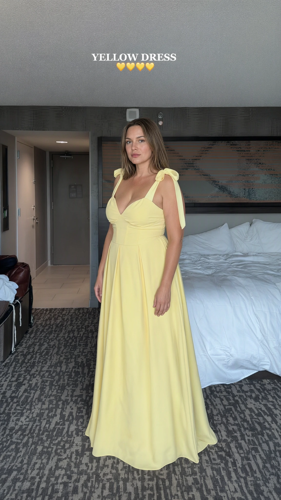 Front view of woman wearing yellow sweetheart maxi dress with tie shoulder straps