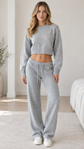 Full front view of model wearing grey knit cropped sweater and wide-leg lounge pants set