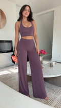 Front view of model wearing dusty mauve racerback crop top and high-waisted wide-leg lounge pants set