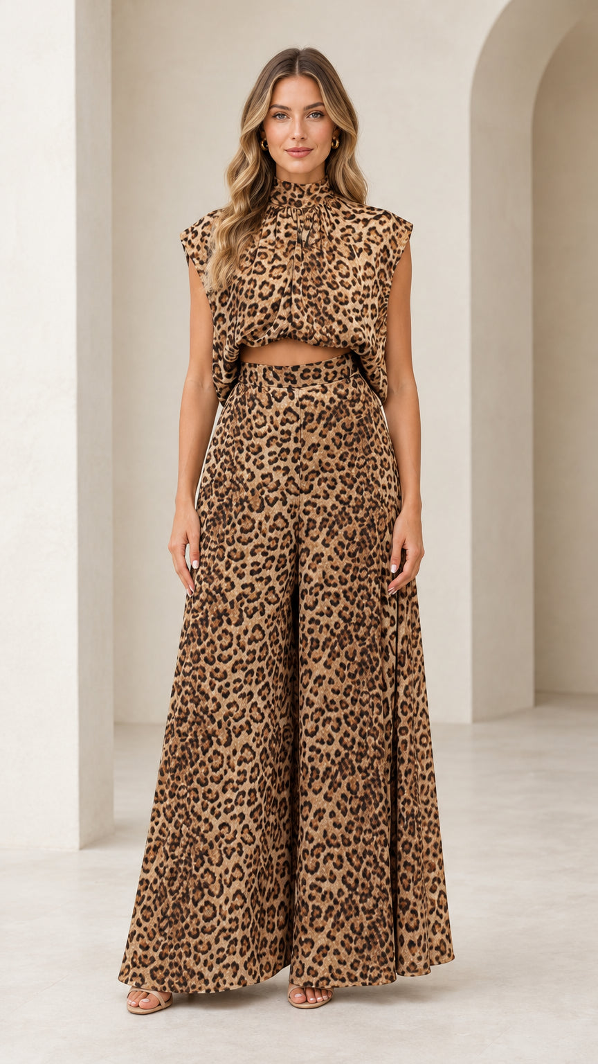 Front full view of woman wearing brown leopard print sleeveless crop top and wide-leg pants set