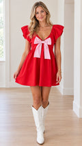 Model wearing red flutter sleeve mini dress with contrast pink bow front view
