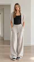 Front full view of woman wearing heather gray knit hooded vest and wide-leg lounge pants
