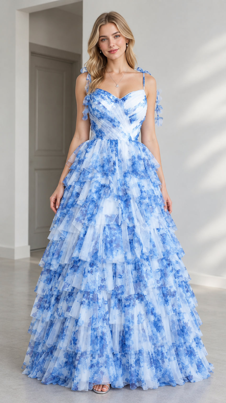 Front view of model wearing blue floral tiered tulle sweetheart evening gown
