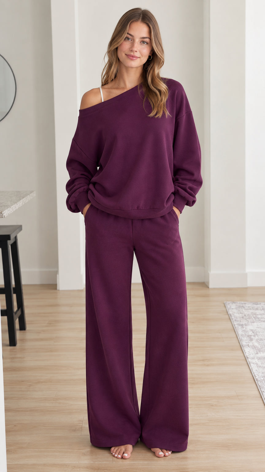 Front view of model wearing plum off-shoulder sweatshirt and wide-leg lounge pants set