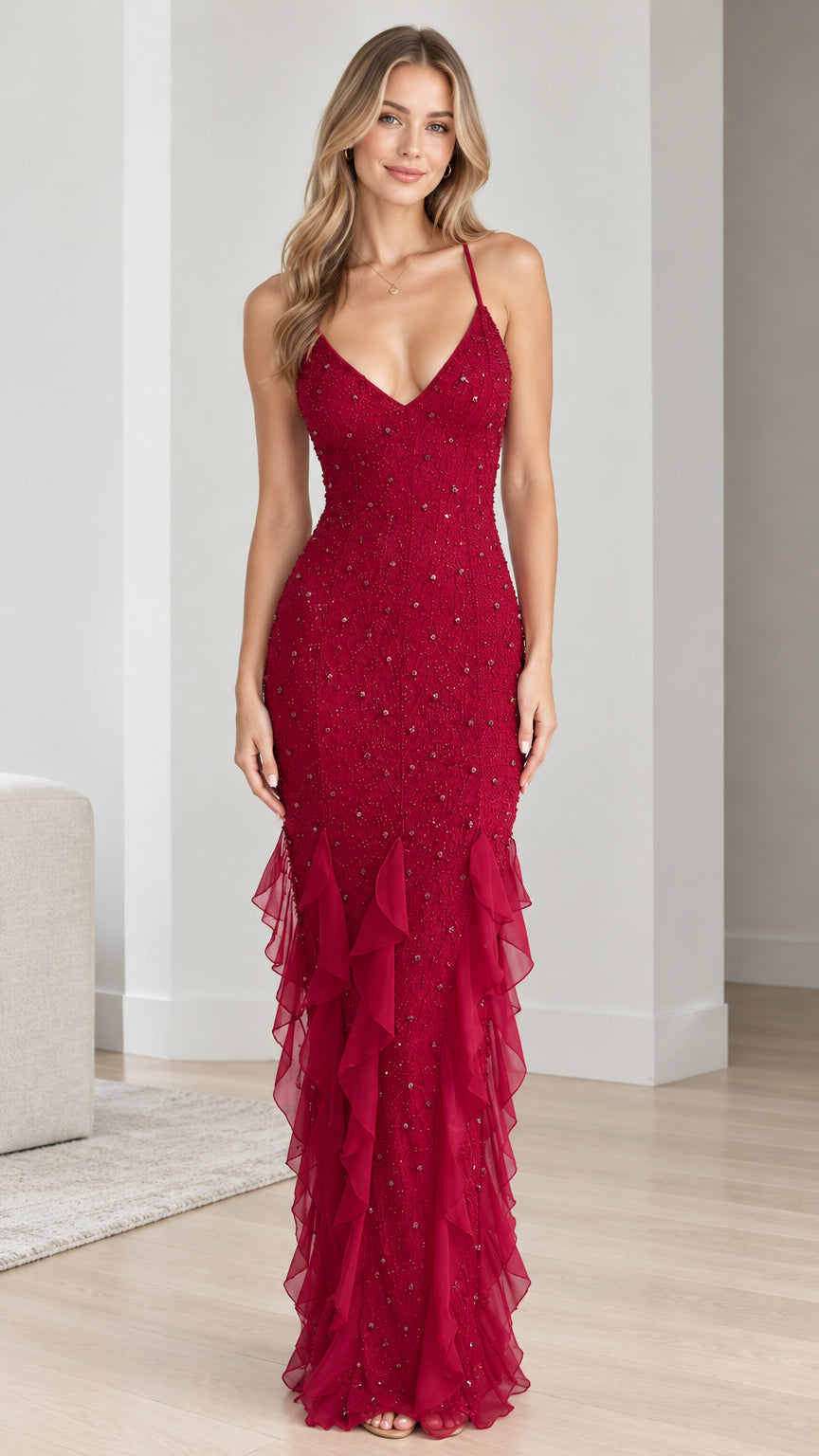 Front view of model wearing a ruby red beaded mermaid evening gown with cascading ruffles