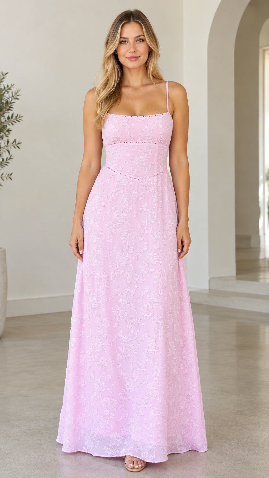 Front view of woman wearing pink floral jacquard maxi dress with square neckline