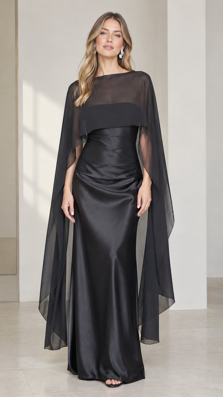 Full front view of black satin evening gown with sheer drape capelet