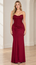 Front full view of burgundy strapless sweetheart corset evening maxi dress with knot waist drape