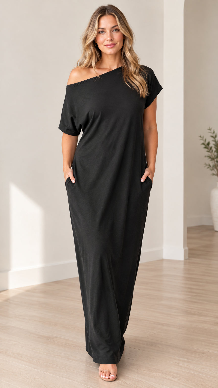 Front full-length view of woman wearing black off-shoulder short sleeve maxi dress with side pockets