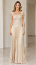Front view of model wearing champagne embroidered lace evening gown with fringe skirt