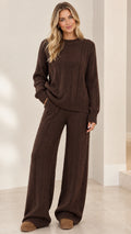 Front full-length view of model wearing brown cable knit crewneck sweater and wide-leg lounge pants set