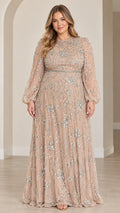 Front full view of woman wearing champagne sequined long sleeve maxi evening gown