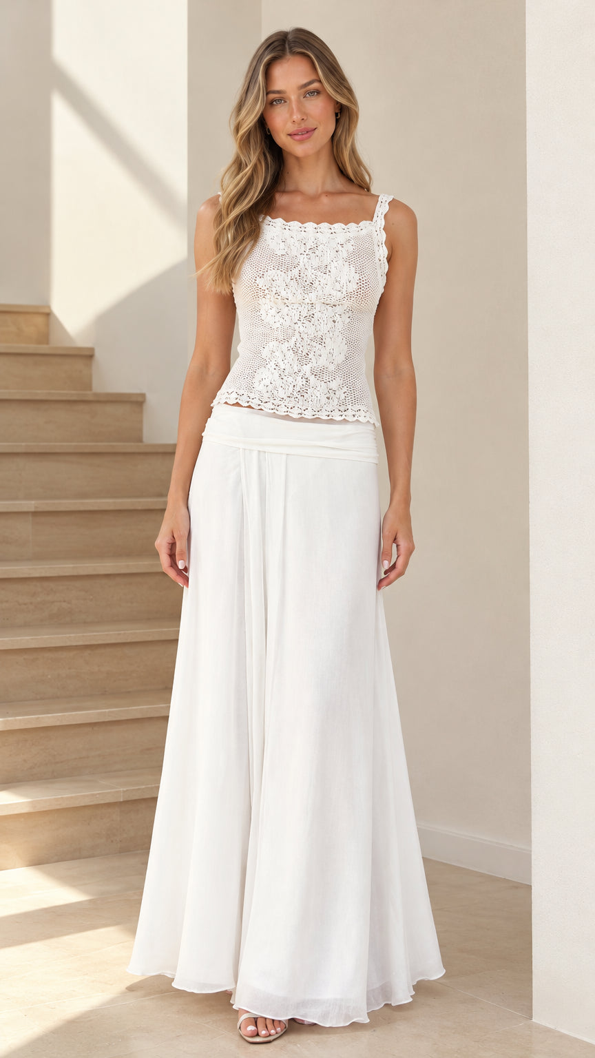 Front full-length view of model wearing white embroidered lace camisole top and flowing maxi skirt set