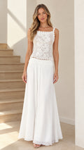 Front full-length view of model wearing white embroidered lace camisole top and flowing maxi skirt set
