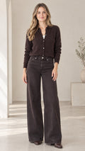 Front view of woman wearing dark brown textured knit polo cardigan with wide-leg pants