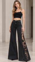 Front full-length view of model wearing washed black high-rise flare jeans with sheer lace side panels