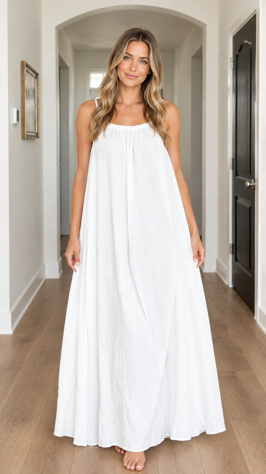 Front view of model wearing white gathered spaghetti strap maxi dress