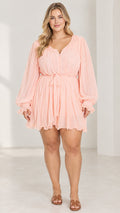 Plus size model wearing Blush Pink long sleeve chiffon tie-waist mini dress front view