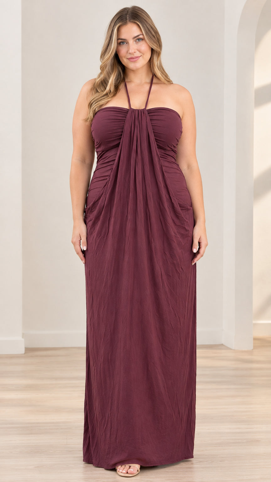 Front full-length view of model wearing burgundy halter neck draped maxi dress