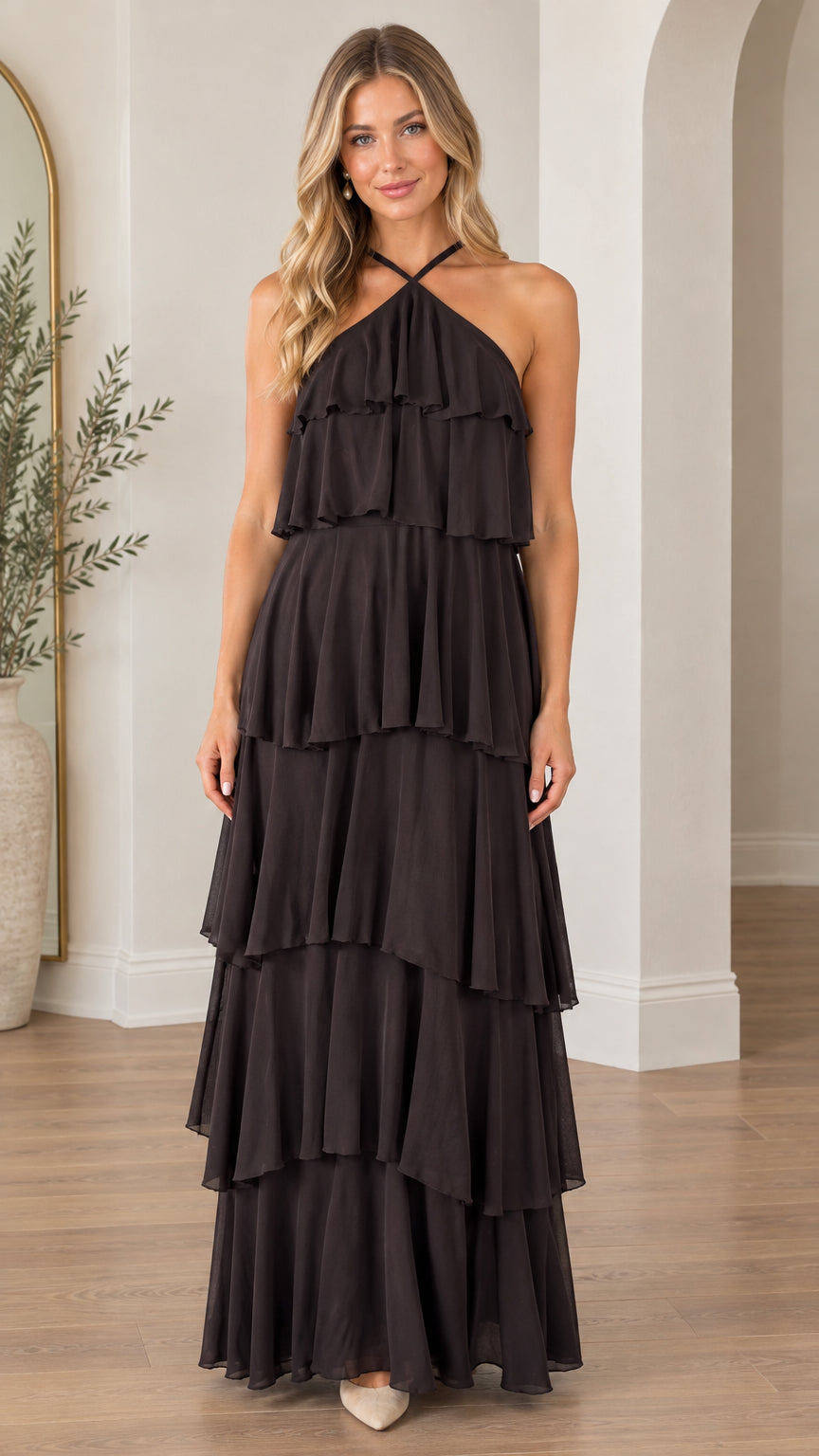 Front view of model wearing black halter neck tiered ruffle maxi dress