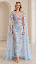 Front view of model wearing light blue floral applique cape evening gown