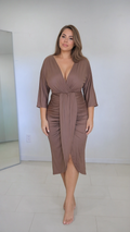 Front full-length view of model wearing mocha brown ruched wrap midi dress with 3/4 sleeves