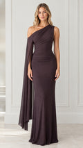 Front view of model wearing dark brown one-shoulder ruched maxi dress with draped cape sleeve