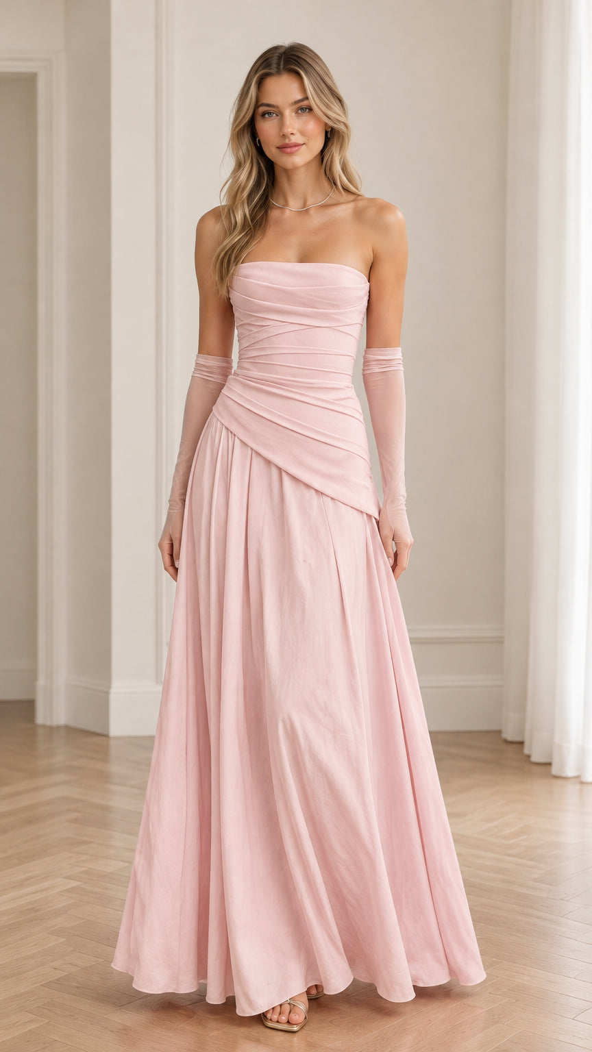 Front view of model in blush pink strapless ruched evening gown with matching sheer gloves