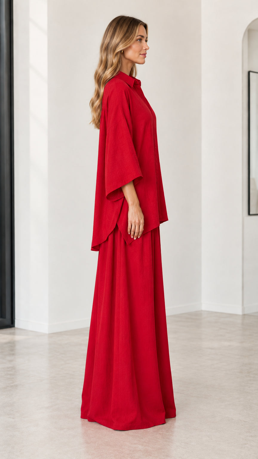 Side profile view of woman wearing red oversized two-piece shirt and flowing palazzo pants set