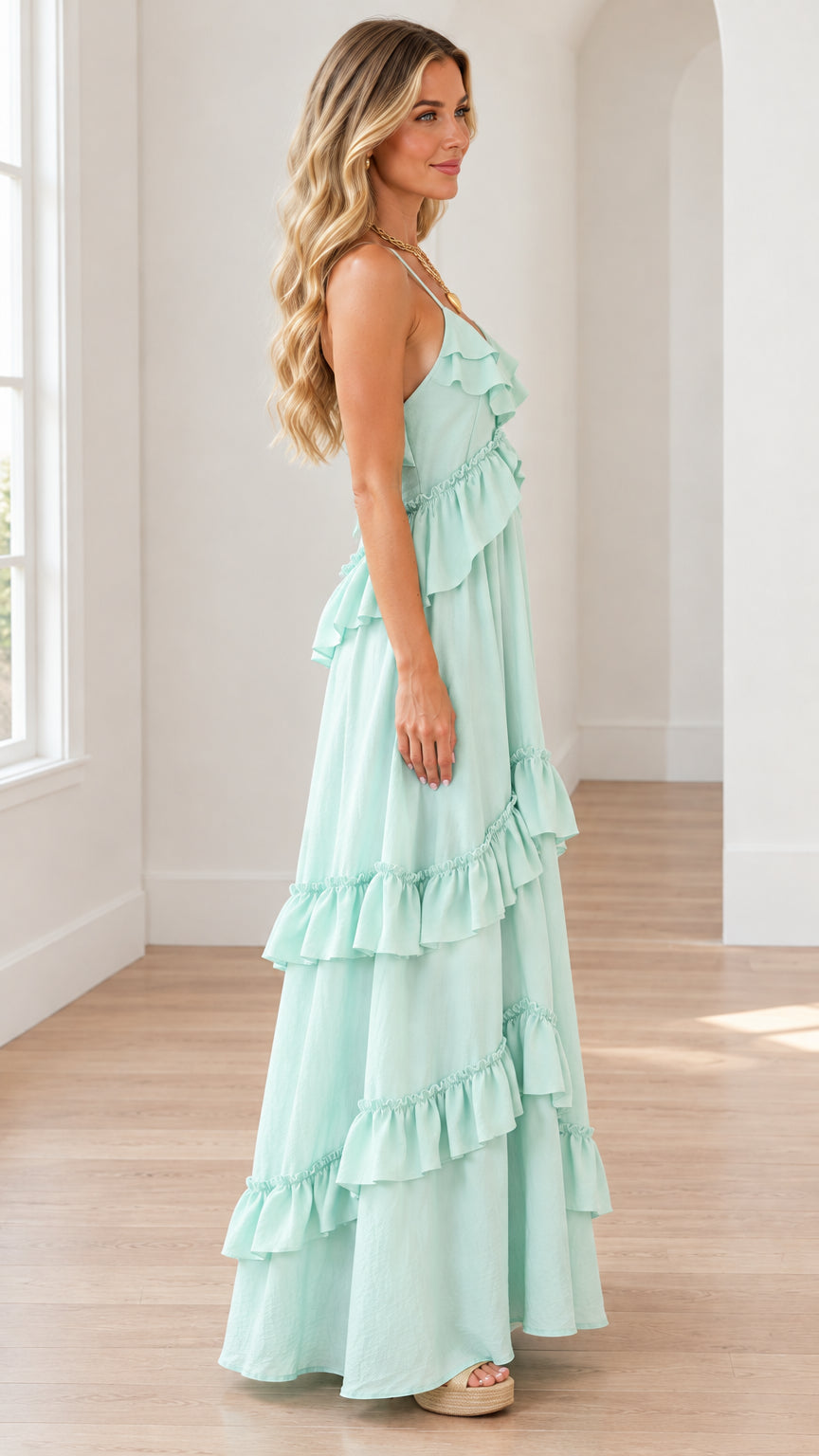 Side profile view of mint green tiered ruffle maxi dress showing layered drape
