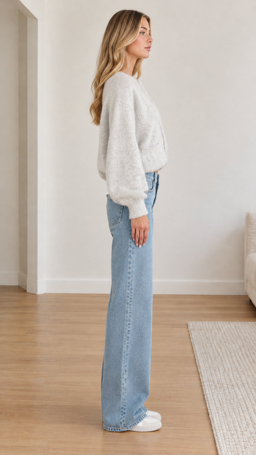 Side profile view of model wearing light grey cropped fuzzy cardigan