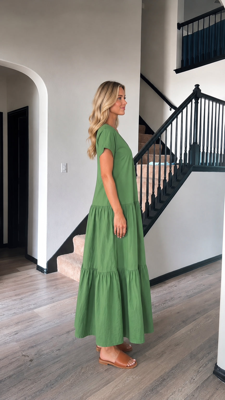 Side profile view of woman wearing green short sleeve tiered maxi dress