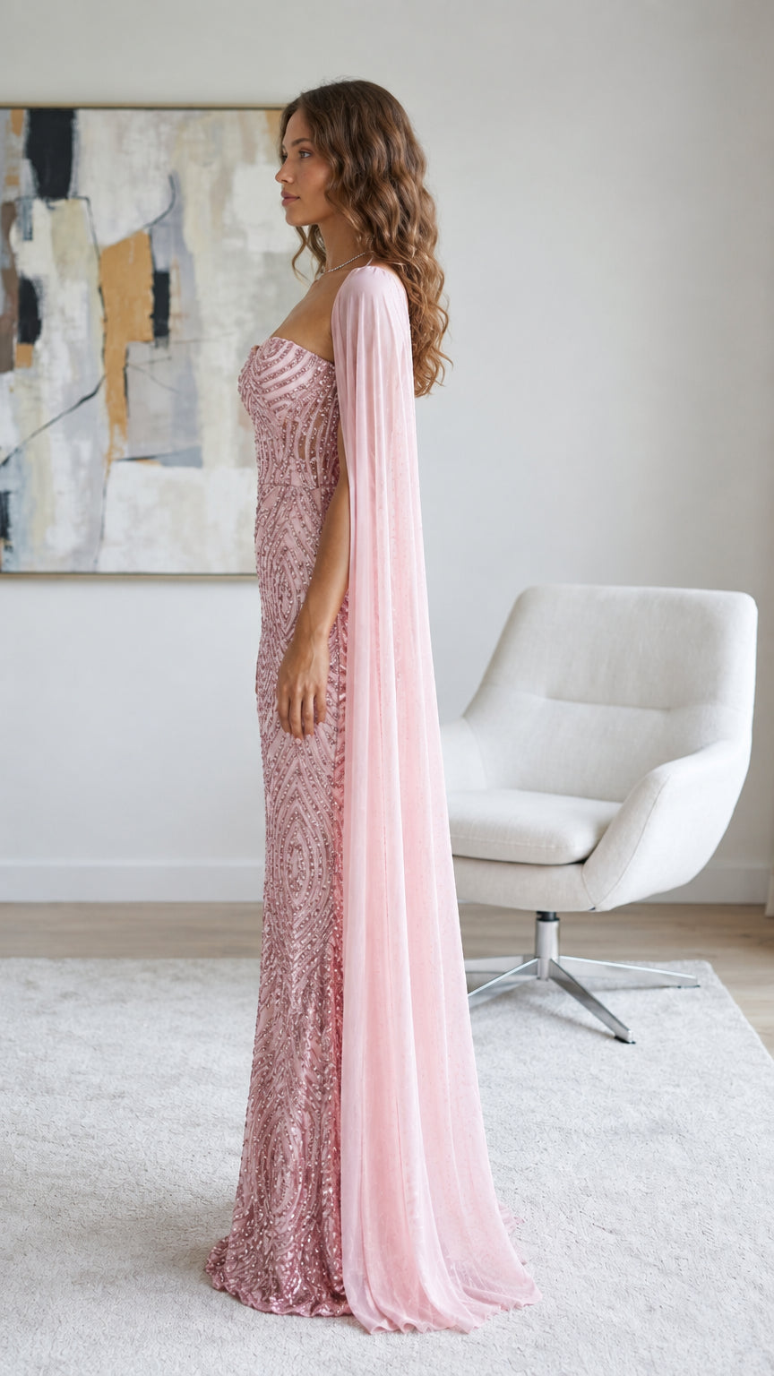 Side profile of woman in dusty pink sequin sweetheart gown with draped cape