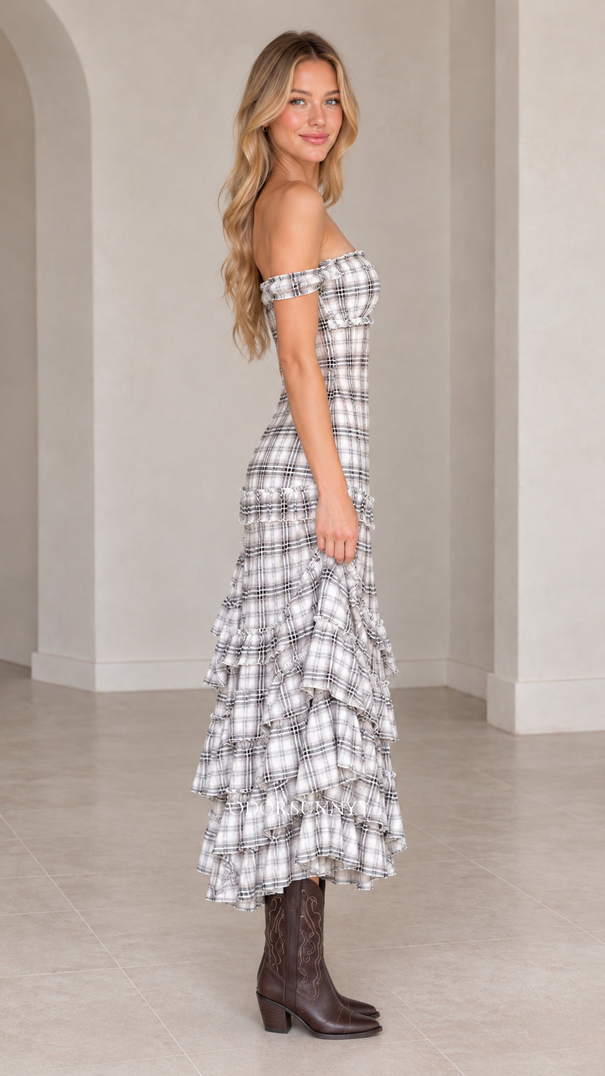 Side profile of model wearing grey plaid off-the-shoulder tiered maxi dress