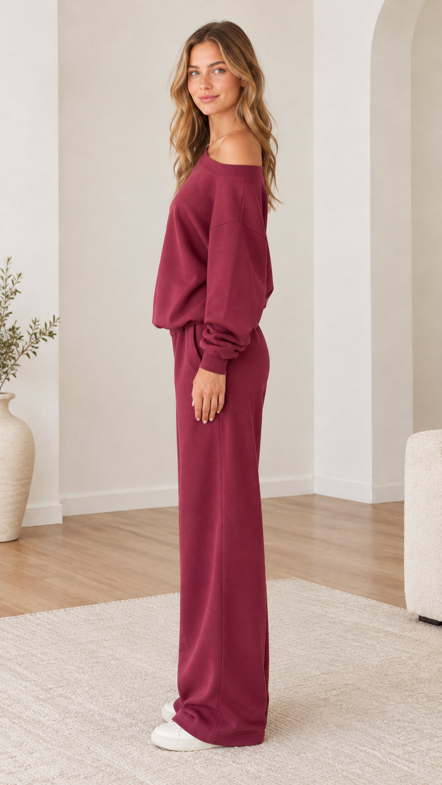 Side angle view of model wearing burgundy loungewear set with wide-leg pants