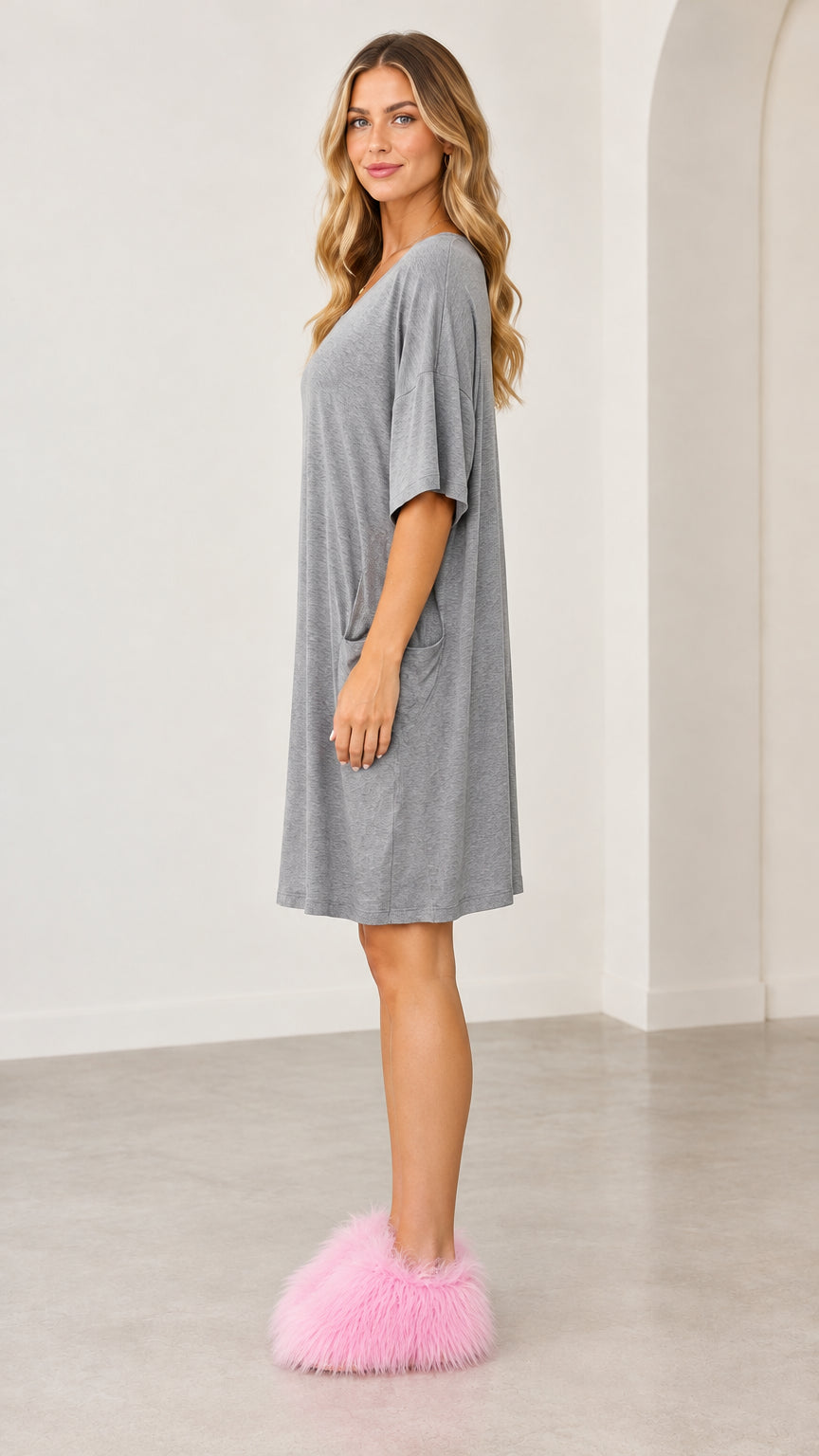 Side profile view of the grey relaxed fit lounge dress showing drape and knee length