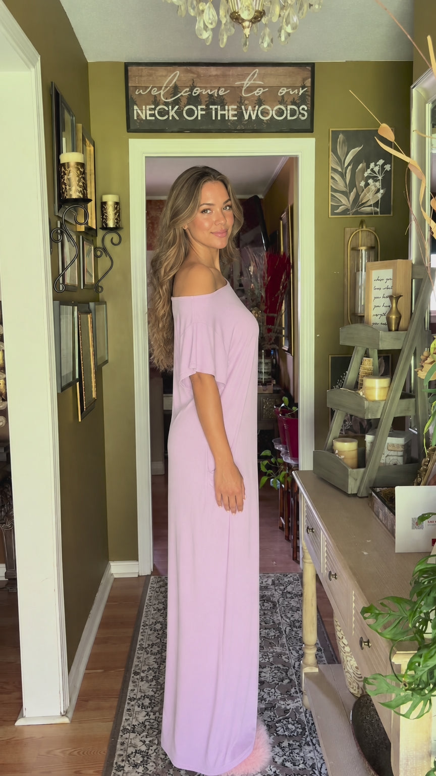 Side profile of model in lavender off-the-shoulder maxi dress