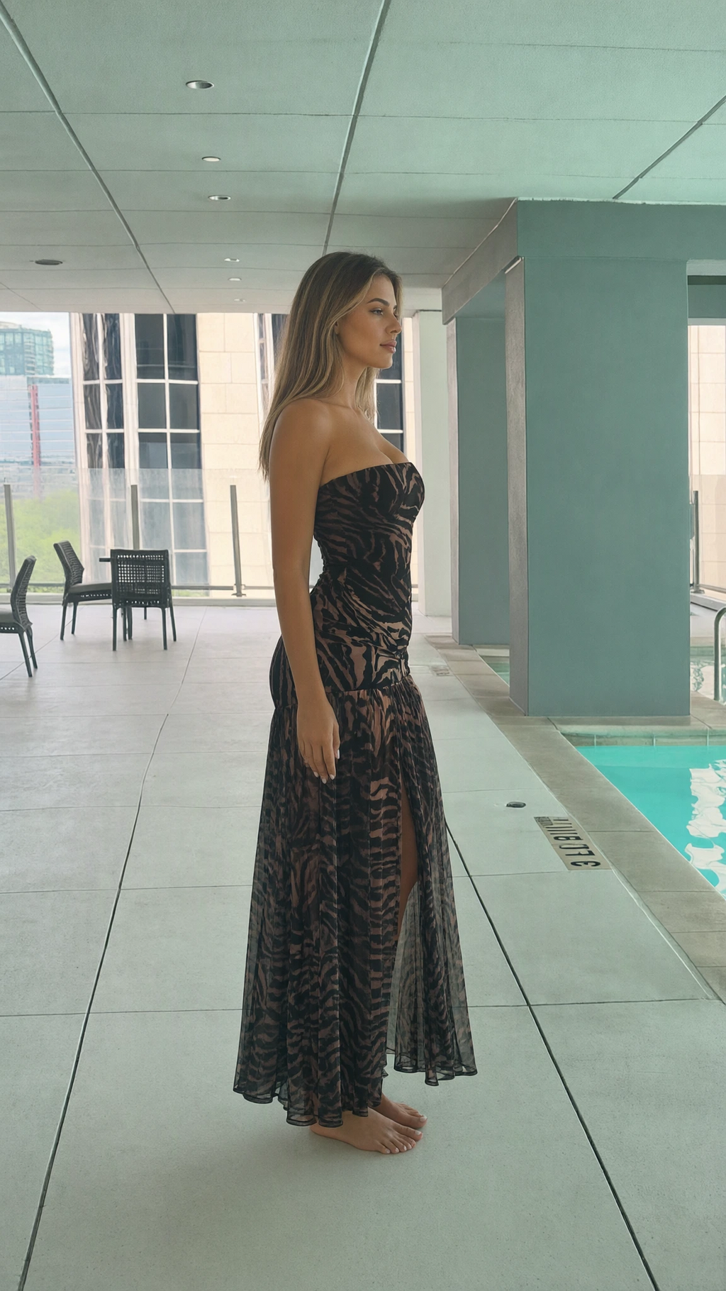 Side profile view of strapless printed maxi dress showing flowy silhouette
