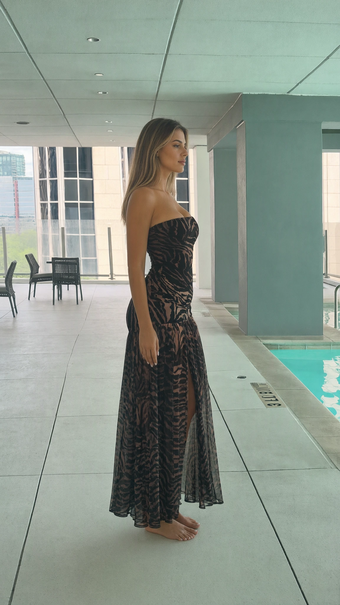 Side profile view of strapless printed maxi dress showing flowy silhouette