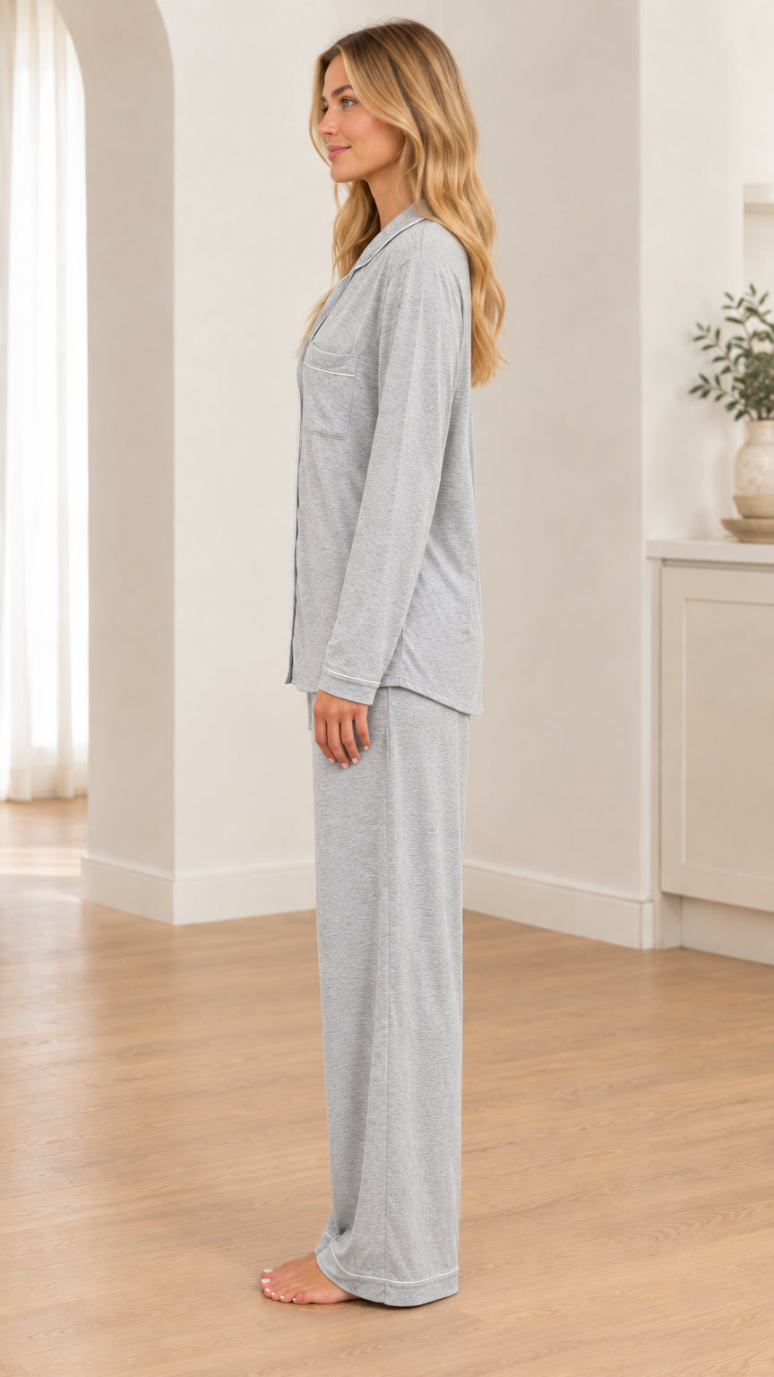 Side profile view of woman wearing Heather Grey long sleeve pajama set and straight-leg pants