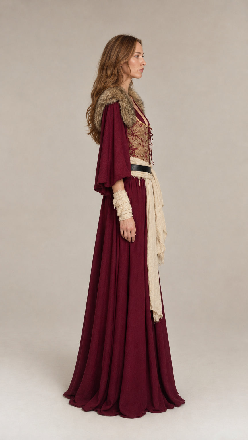 Side profile view of burgundy Renaissance maxi dress showing flared sleeves and flowing drape