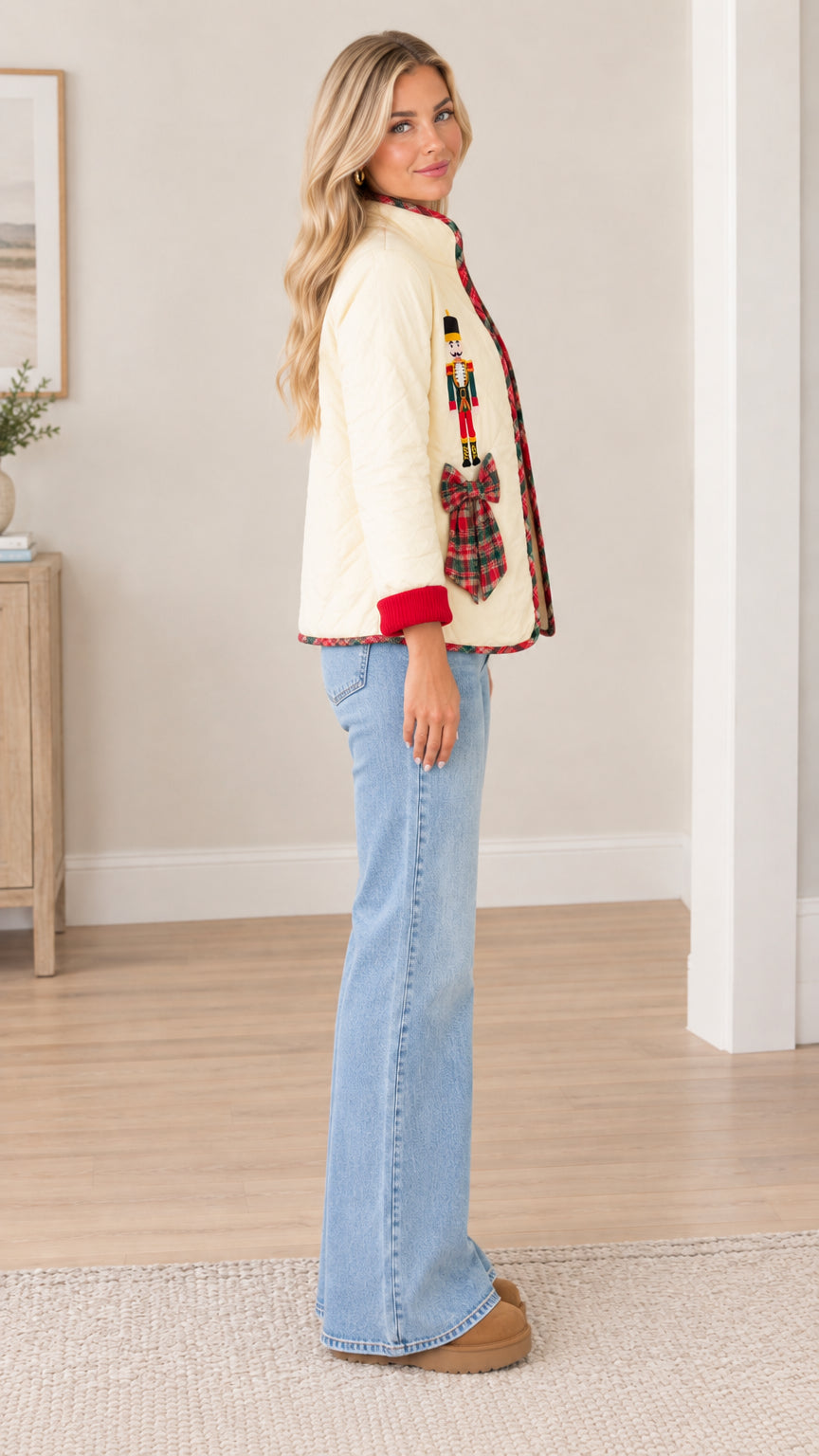 Side profile view of cream quilted nutcracker jacket paired with flare jeans
